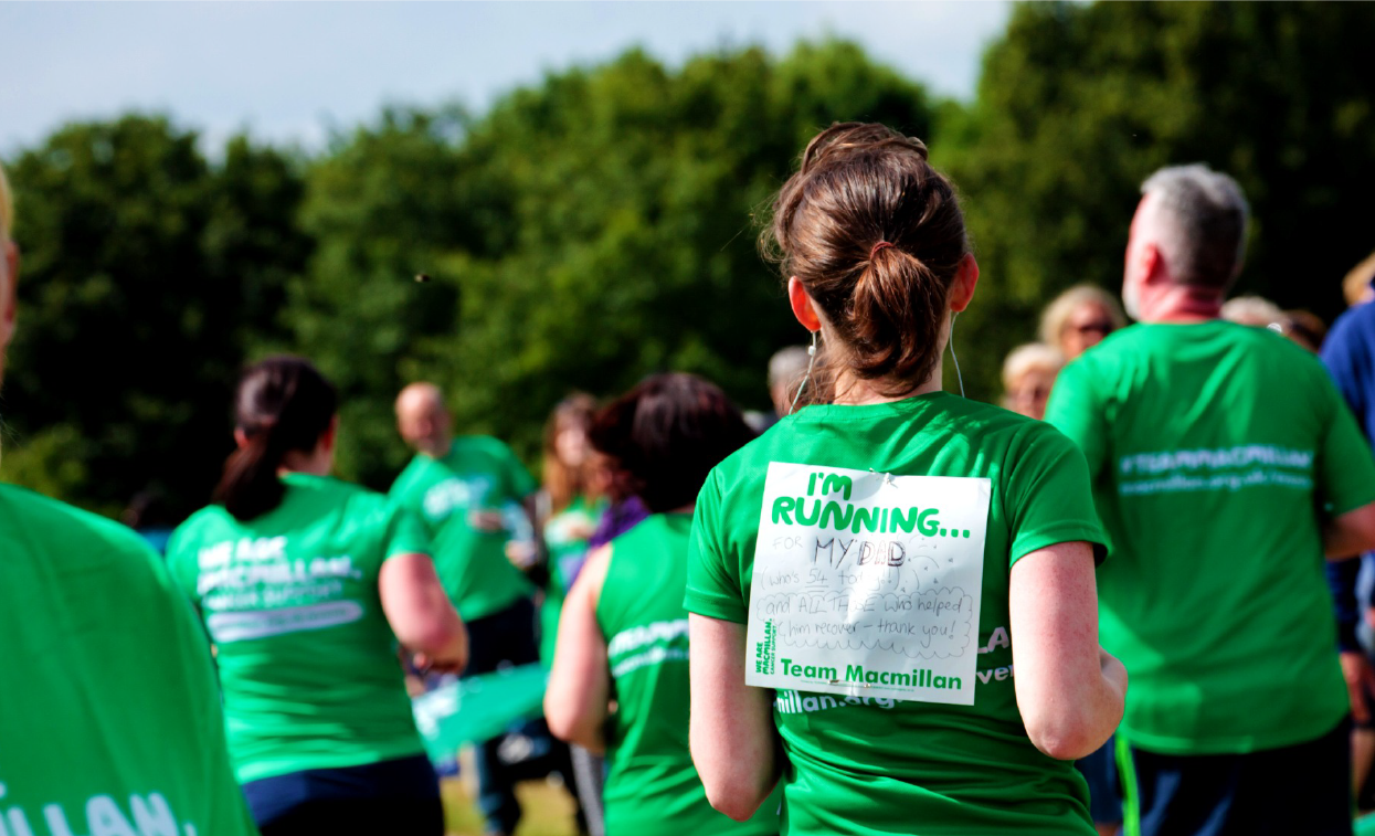 runners taking part in charity run with Macmillan branding on their t shirts